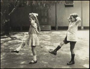 school children performing balancing exercises in 1913